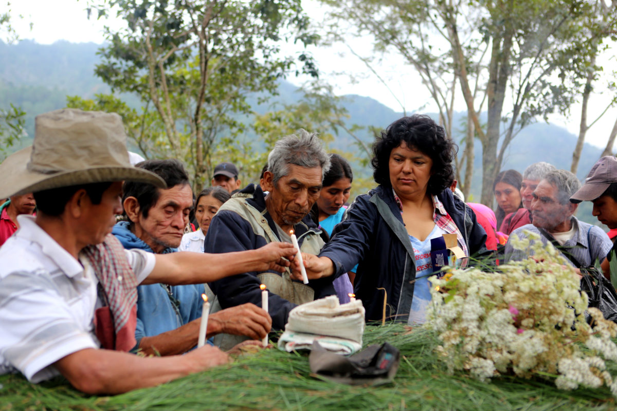Berta Caceres lighting candles with community members