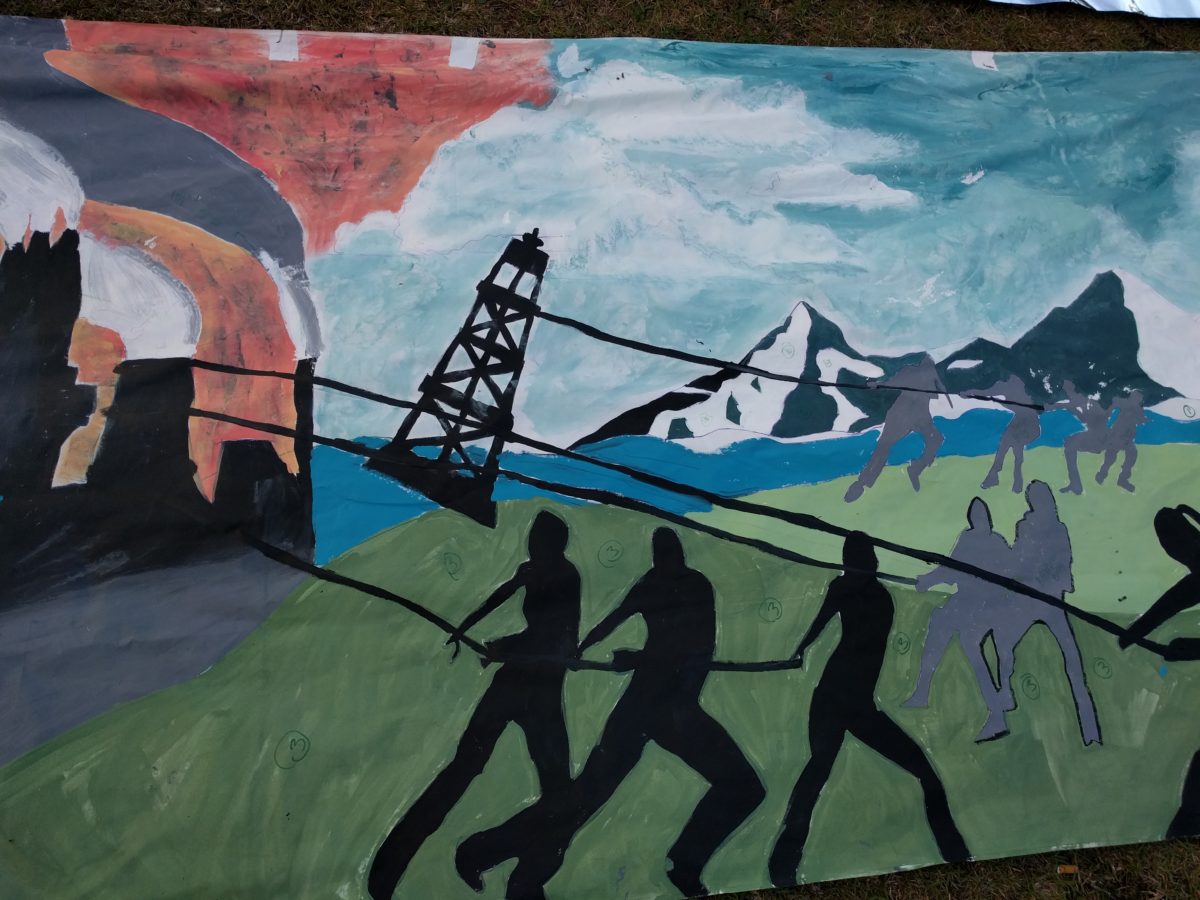 Hand painted banner depicting the pulling down of an oil rig