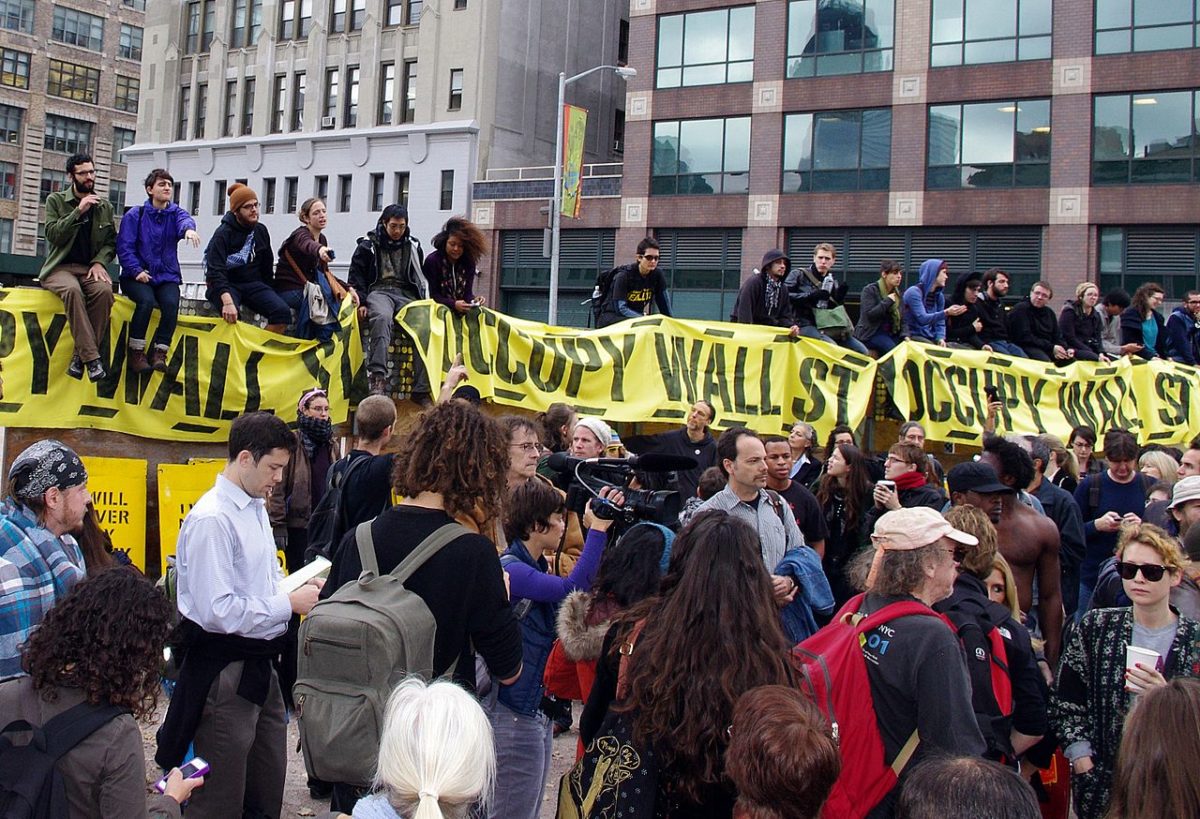 A group of activists holding Occupy Wall Street banners