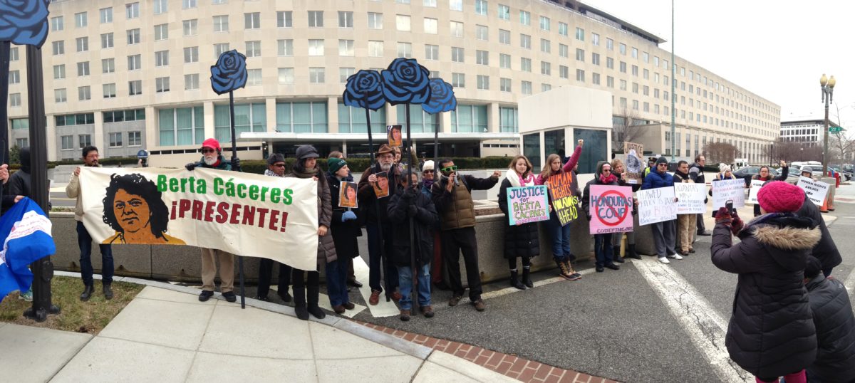 Activists lined up holding banners and signs supporting Berta Cáceres