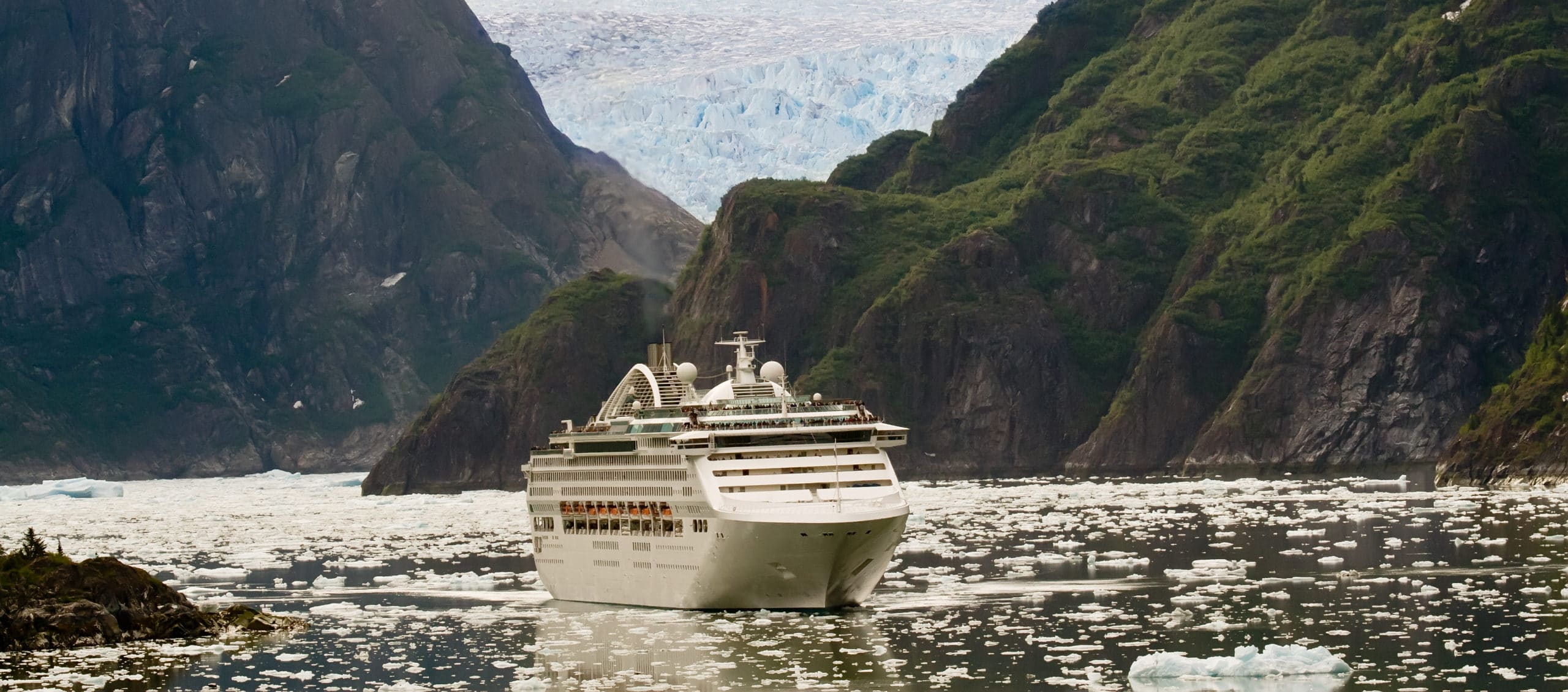 A cruise ship sailing amongst mountains