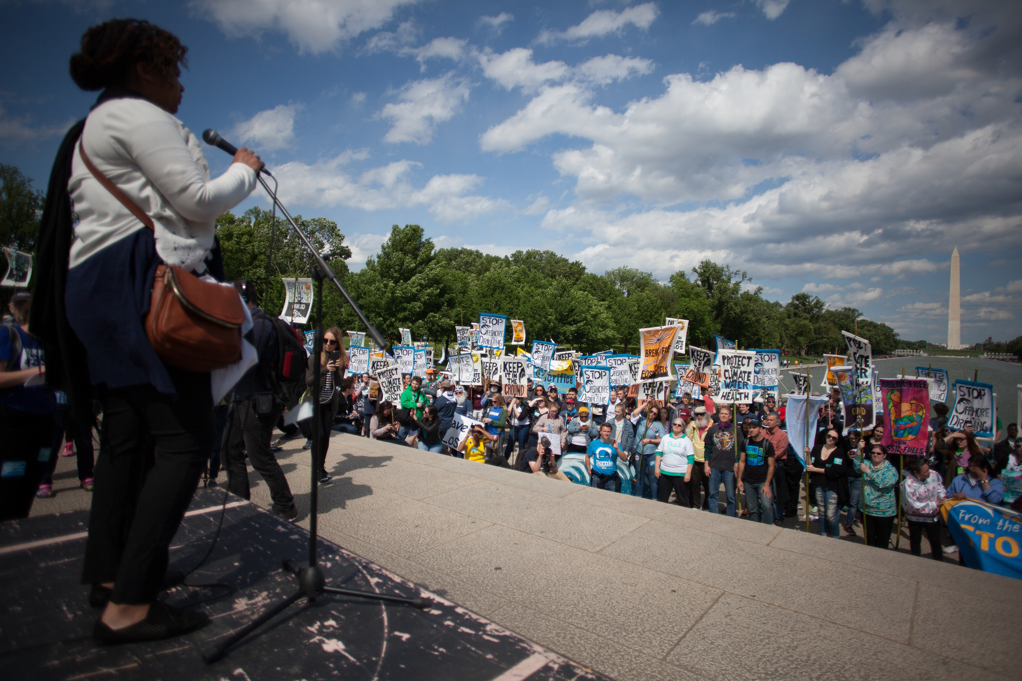 Speaker at the Break Free action in D.C. in front of activists and the reflecting pool.