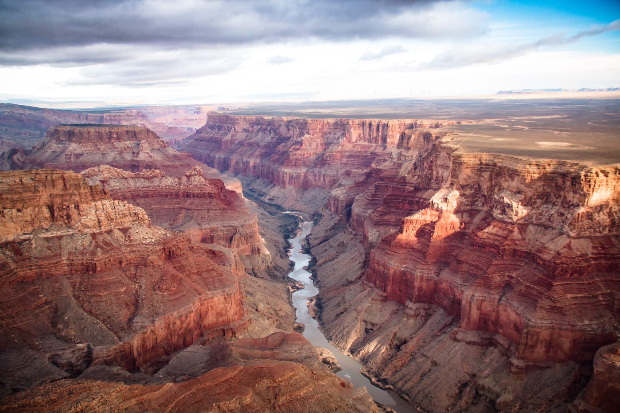 May contain a vast canyon with a river winding through it.