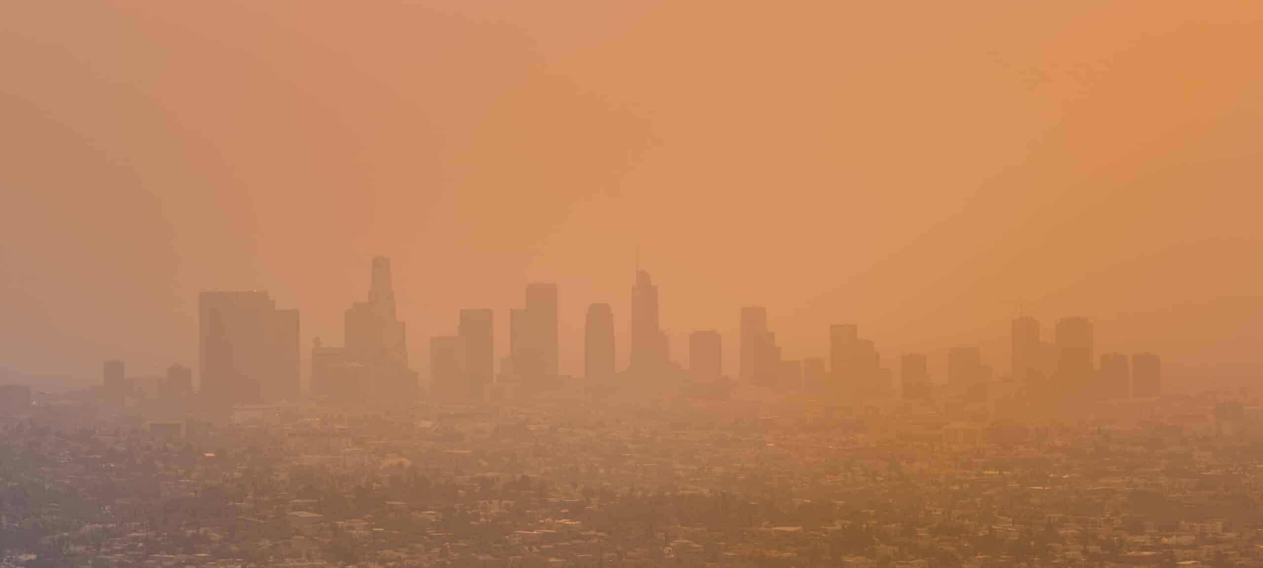 May contain city skyline in hazy orange light.