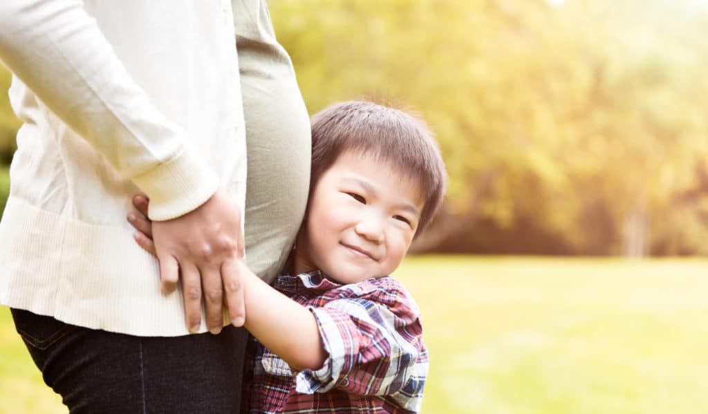 Young Boy Hugging His Mother's Pregnant Belly