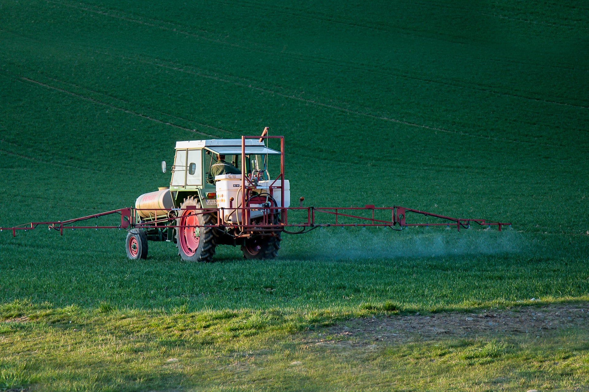 Farmer Spraying Pesticides With Tractor