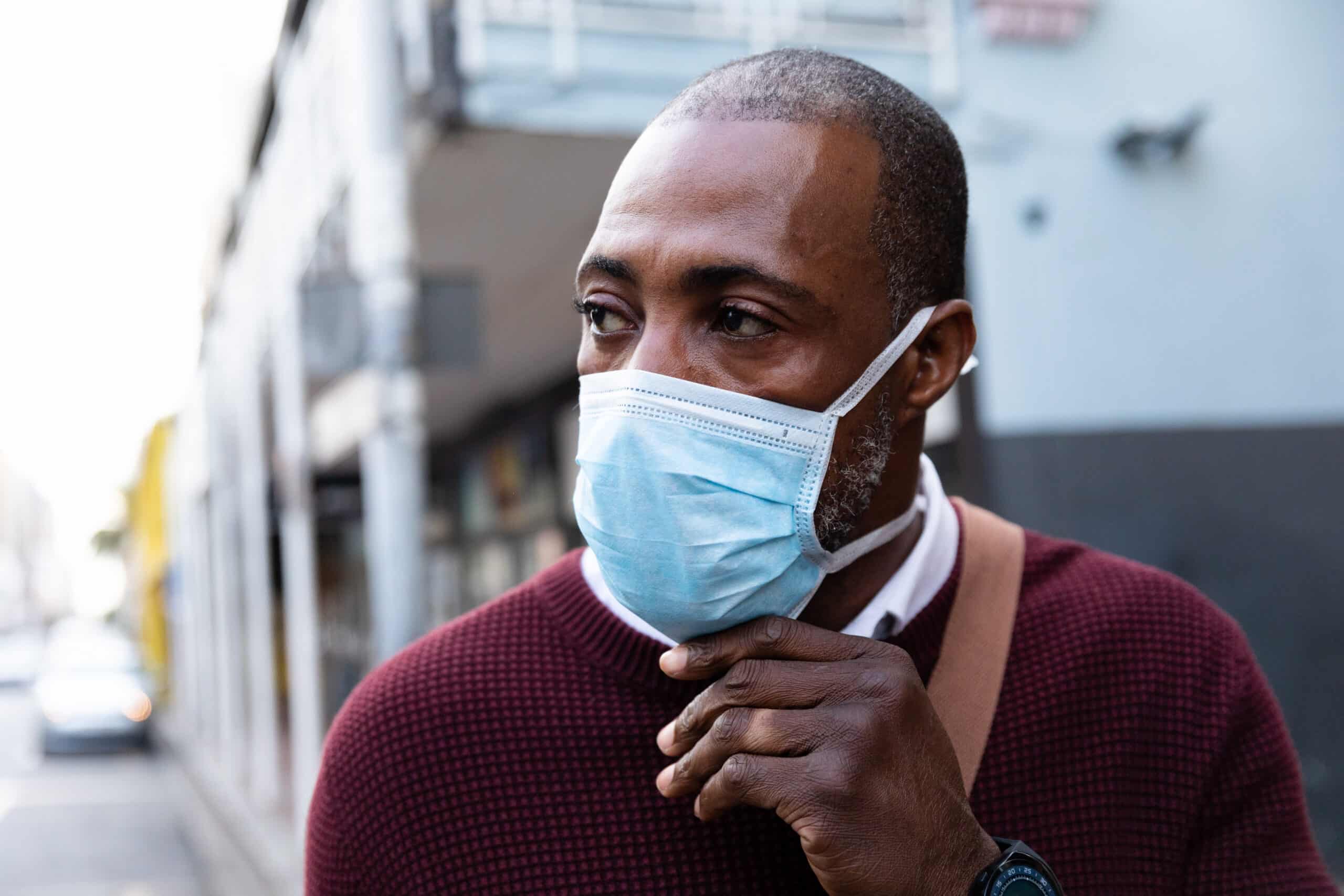 May contain one person wearing a light blue medical mask and maroon sweater.