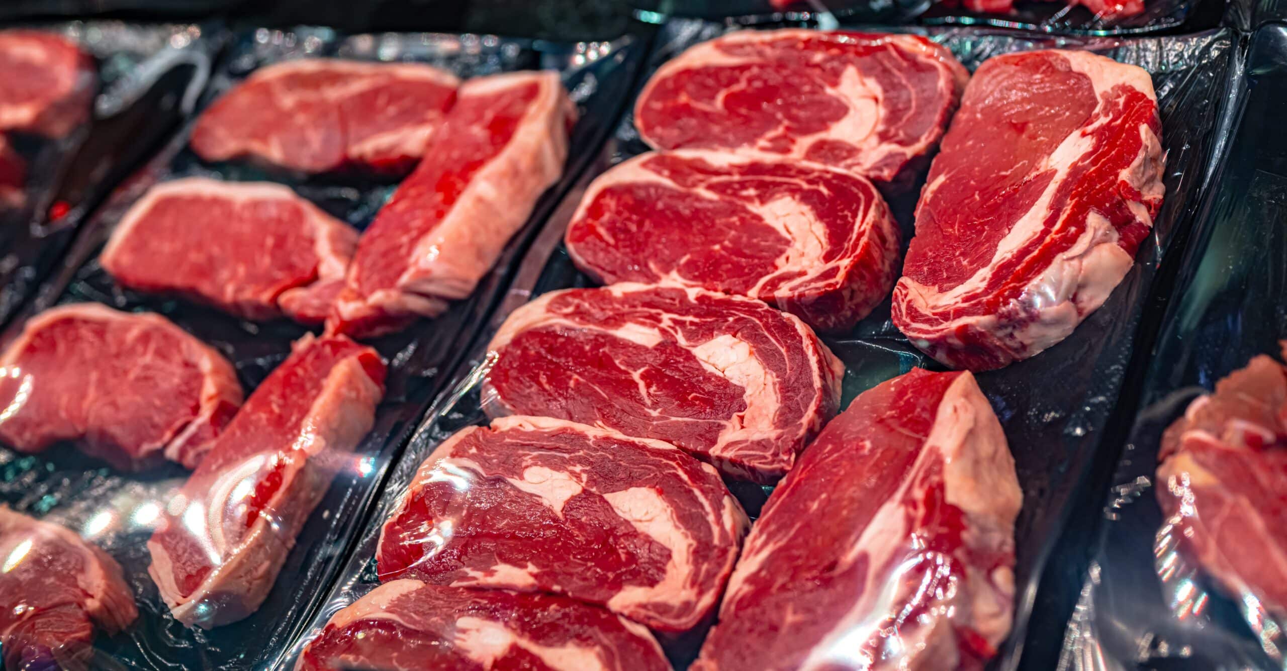 May contain several raw steaks on display.
