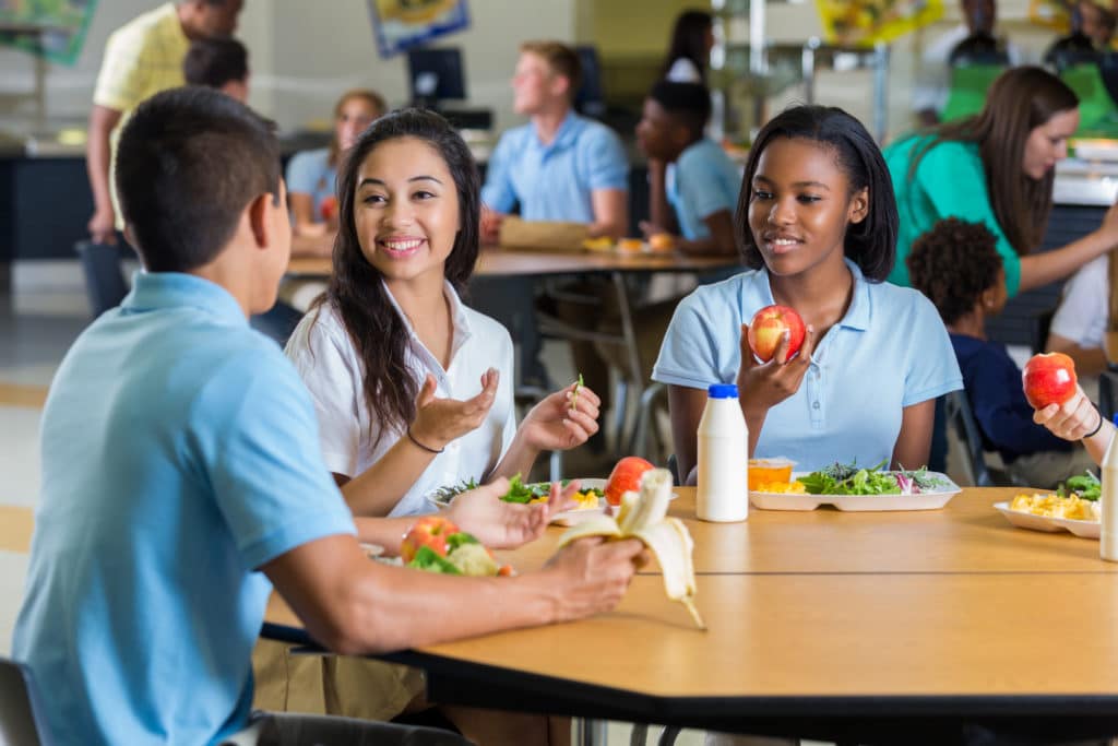friends eat lunch in school cafeteria