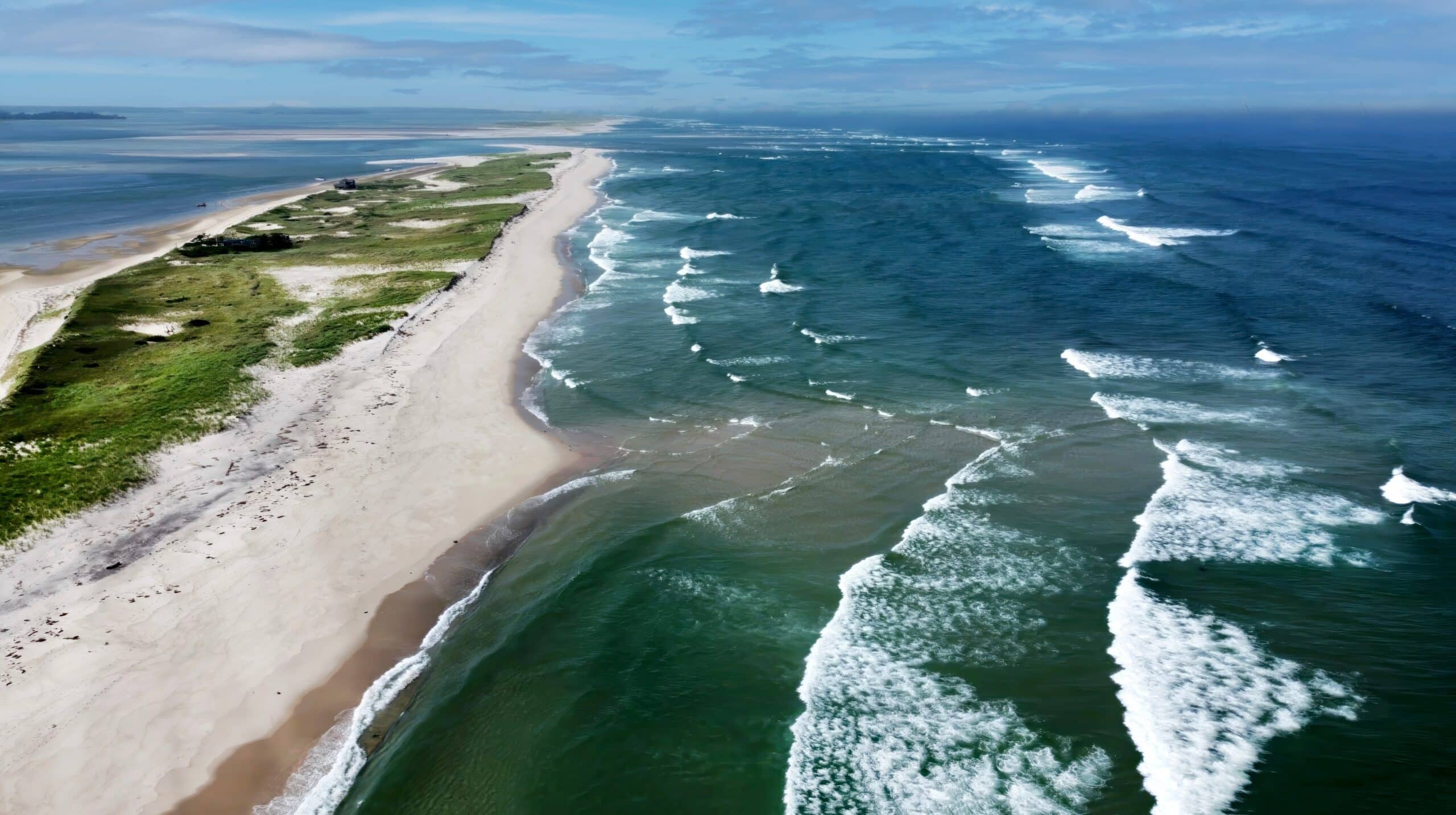 May contain a person on a sandy beach with waves crashing.
