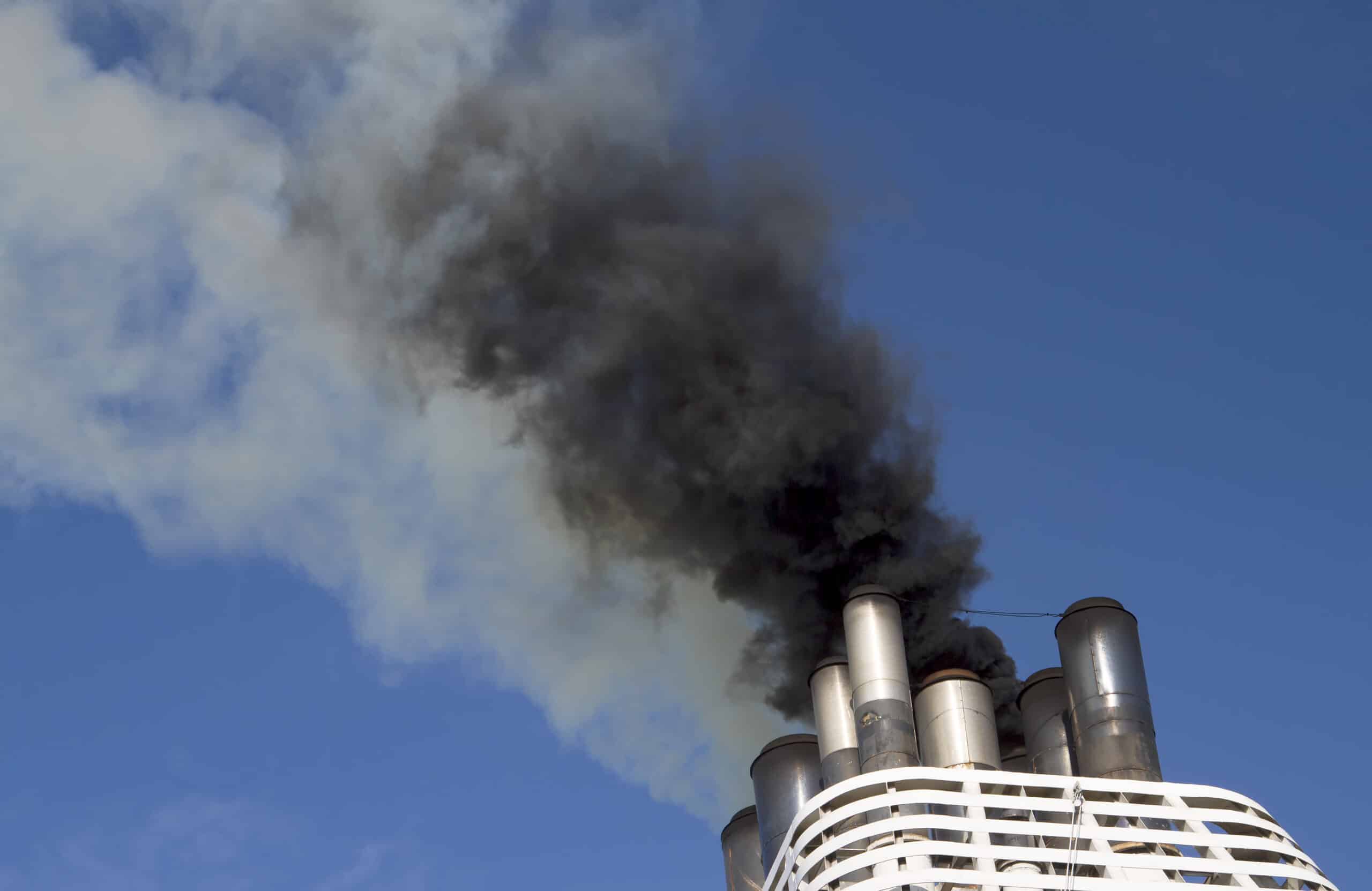 May contain smoke billowing from ship smokestacks against a blue sky.