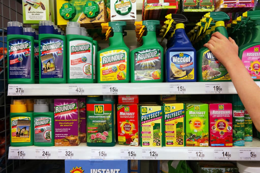 May contain a person's arm reaching for a bottle of weed killer.