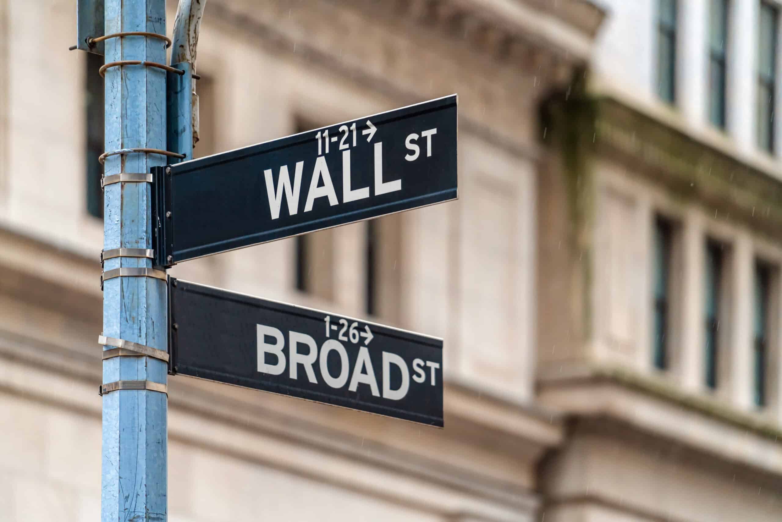 May contain two street signs, one for Wall St and one for Broad St.