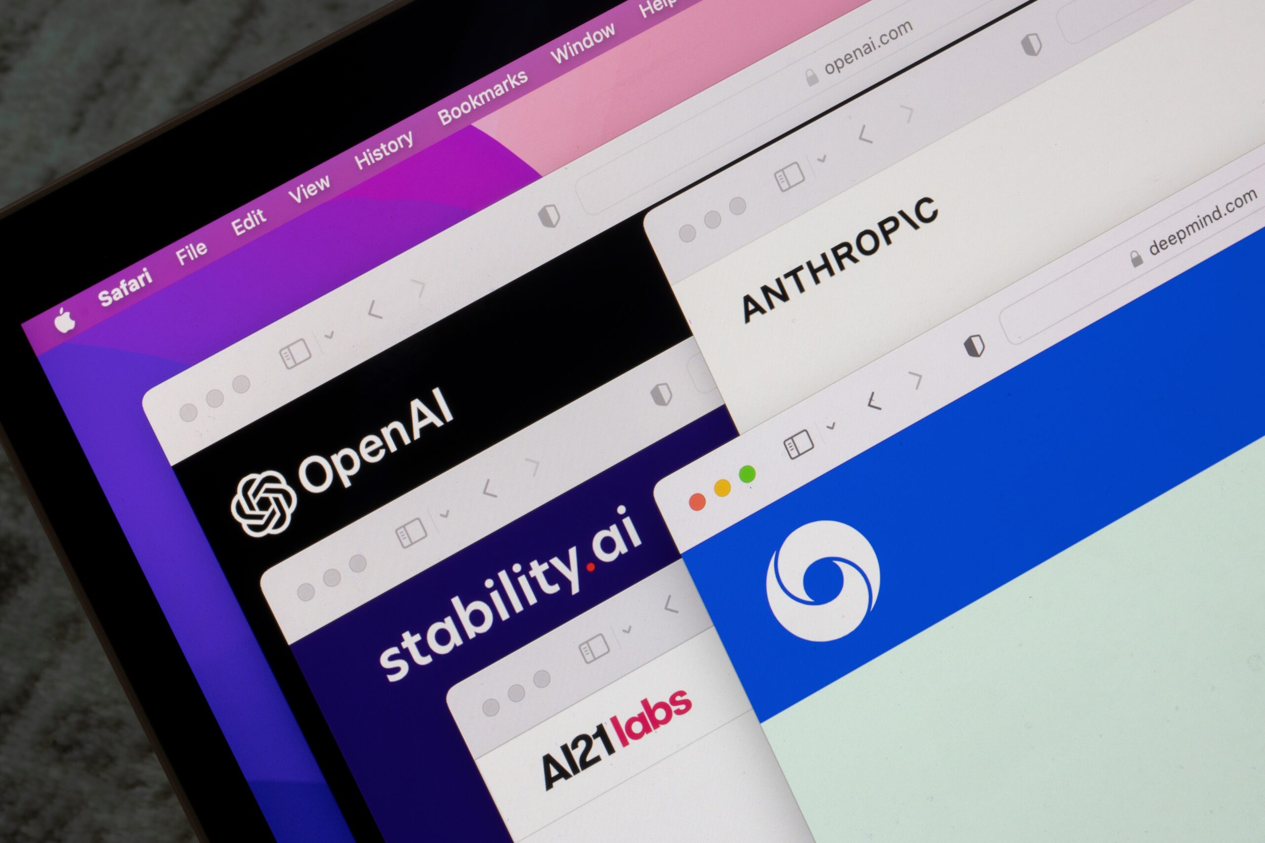 May contain multiple browser windows displaying logos of AI companies like OpenAI and Anthropic.