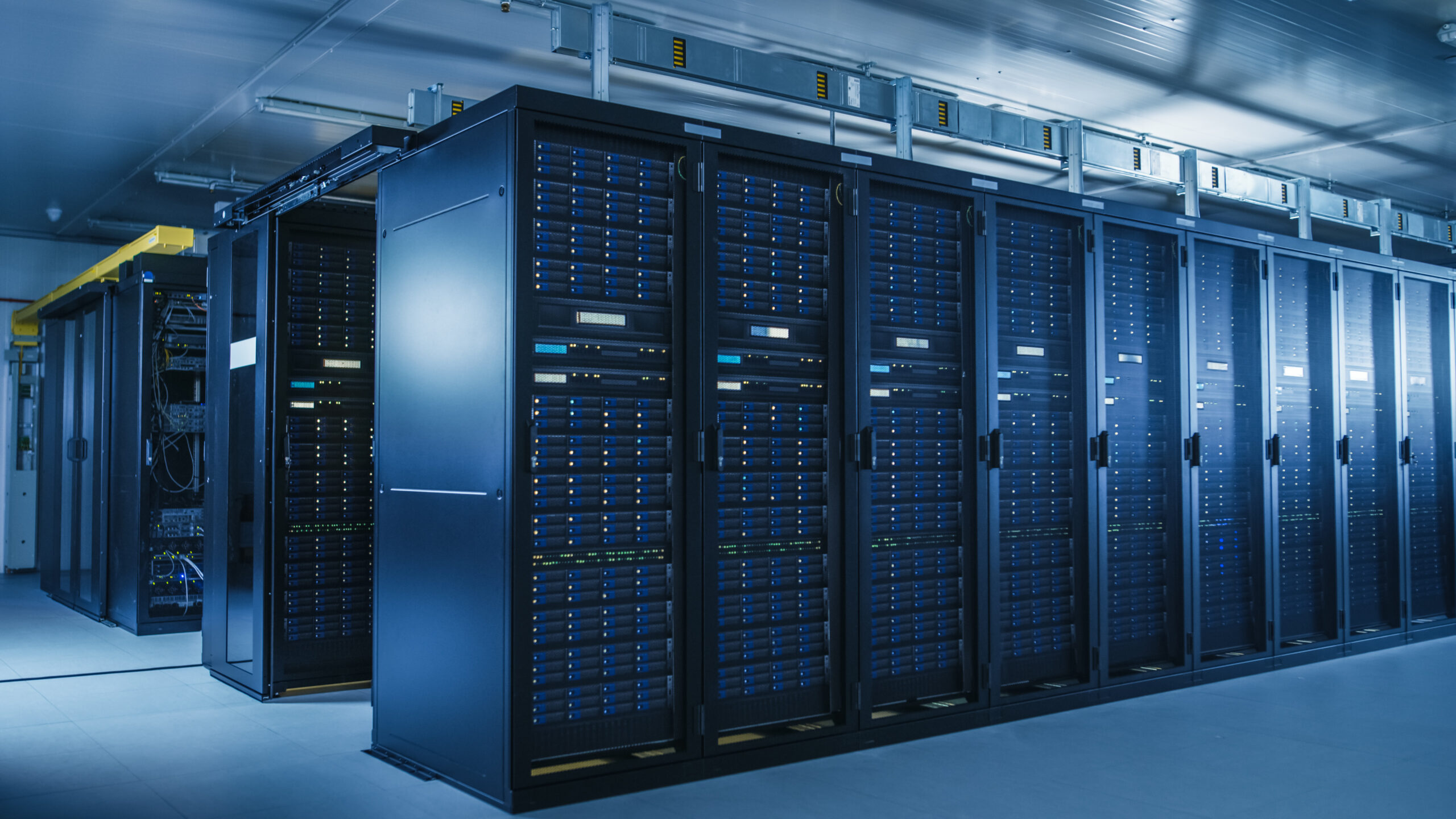 May contain rows of server racks in a data center.